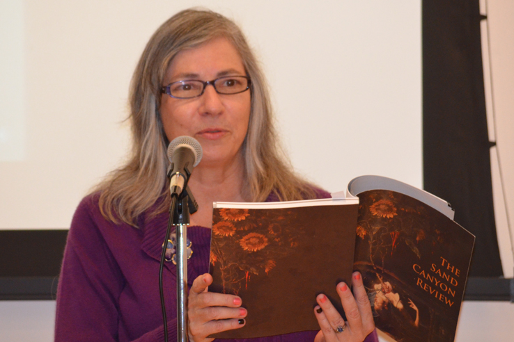 Woman reading at a microphone